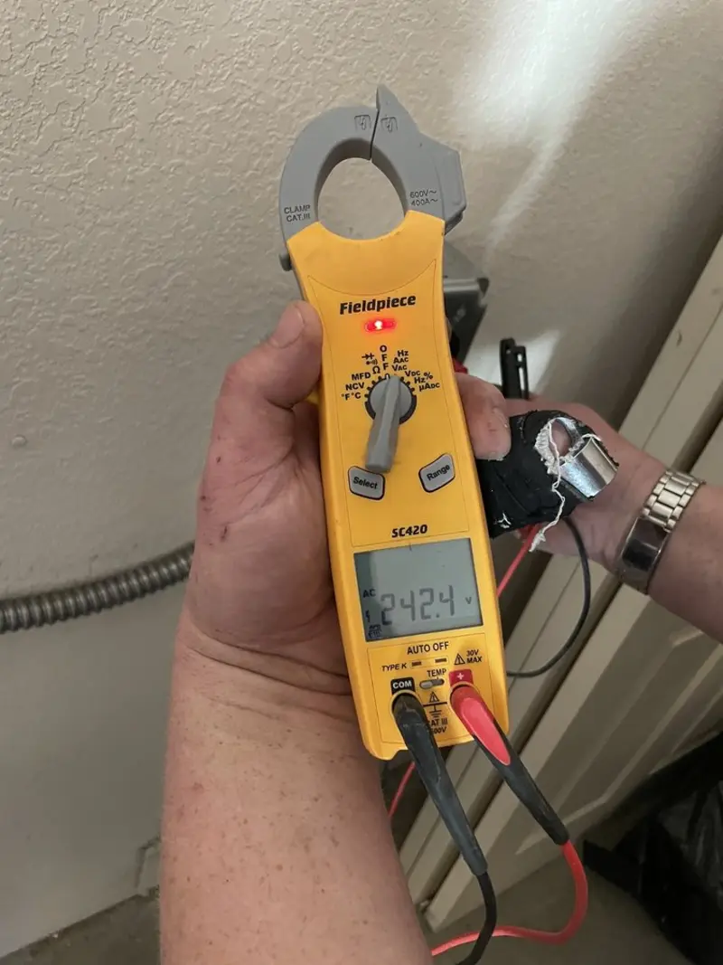 Voltage testing with clamp meter during Ceiling Fan Installation in Brookhaven